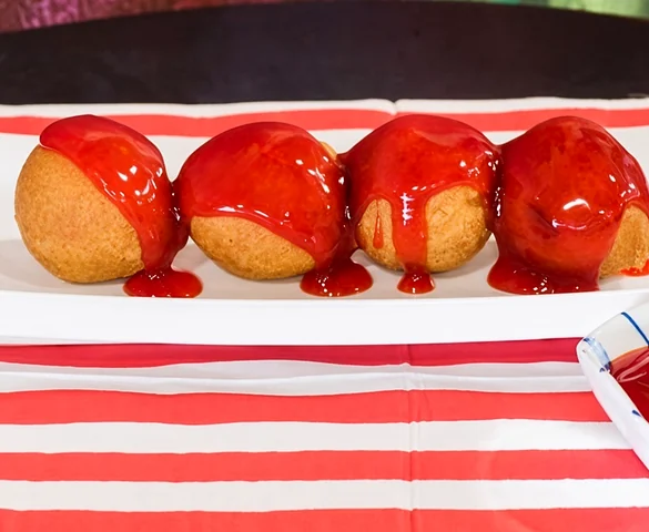 Chicken balls topped with sweet and sour sauce
